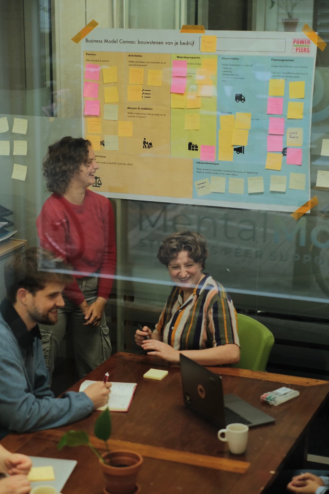 a group of people discussing a topic in a room